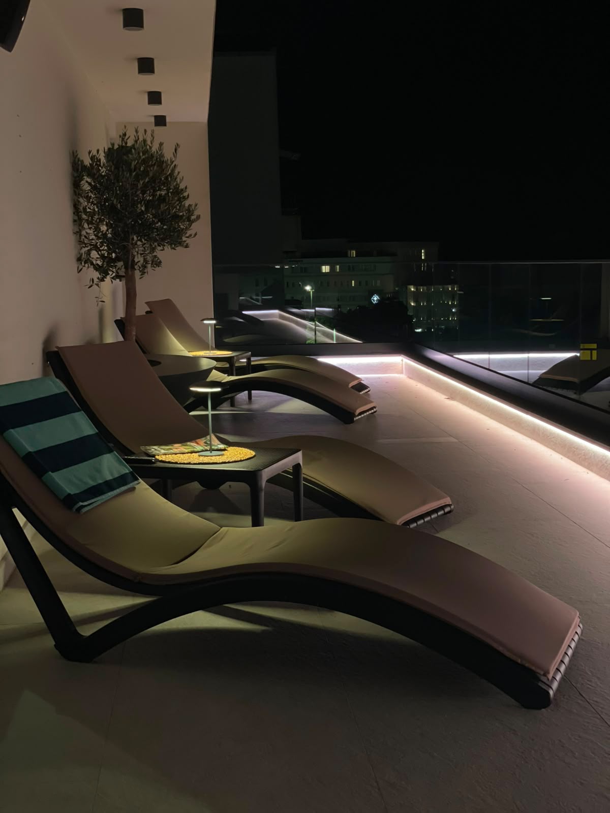 Rooftop terrace lounge lit for a live music evening at Hotel Bulevar